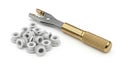 Riveting tool and white plastic grommets on a white background Royalty Free Stock Photo