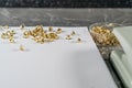 Rivets scattered on a white sheet lying on a gray marble table