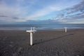 Riviera Romagnola beach near Rimini and Riccione, with typical umbrella supports; nobody; desolation mood Royalty Free Stock Photo