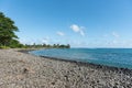 Riviere des Galets Beach in Mauritius. Black stones and Indian Ocean