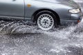 Ãâriving car on flooded road during flood caused by torrential rains. Cars float on water, flooding streets. Splash on car. Royalty Free Stock Photo