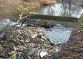 RIVNE, UKRAINE - DECEMBER, 2019: Trash in the nature. Bottles near the river. Pollution of environment