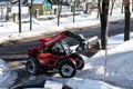 RIVNE, UKRAINE - FABRUARY 16, 2021. Removing snow from the streets with a tractor. A bulldozer with a bucket clears snow from the