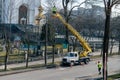 RIVNE, UKRAINE - FEBRUARY 16, 2023. A team of electricians are repairing a street lamp. Replacing lamps on a street lamp