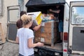 RIVNE, UKRAINE - JUNE 18, 2023. Unloading humanitarian aid to Ukraine. Ukrainian volunteers unloading boxes with humanitarian aid