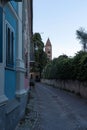 Rivoli old historical city centre, cobble stoned street and bell tower. Piedmont, Italy. Royalty Free Stock Photo