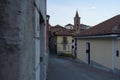 Rivoli old historical city centre, cobble stoned street and bell tower. Piedmont, Italy. Royalty Free Stock Photo