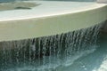Rivulets of Water Fall From Fountain Edge