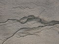 Rivulets of water on a fine sand beach at low tide Royalty Free Stock Photo