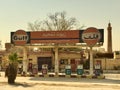 RIYADH, SAUDI ARABIA - AUGUST 31, 2019: An abandoned gas station with signs in English and Arabic on the side of the road