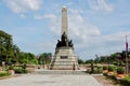 Rizal Park in downtown Manila on a beautiful day with blue sky and clouds looking towards the sculpture, park, and the Philippines