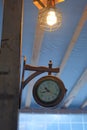 A single lamb over the ancient style clock, watch. Wooden made clock