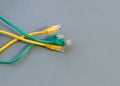 Rj45 green and yellow wire internet signal transmission on gray background