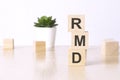 RMD - Required Minimum Distribution - text on wooden cubes on a white background Royalty Free Stock Photo