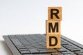 RMD text on keyboard for your desing, Front view concept. Wooden block with words RMD - acronim RMD - Required Minimum Royalty Free Stock Photo