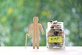 RMF - Retirement Mutual Fund, Senior man with RMF word and stack of coins money in glass bottle on natural green background, Save