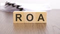 roa text on wooden blocks. wooden background. foreground Royalty Free Stock Photo