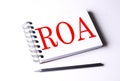 ROA word on notebook on white background