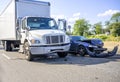 Road accident with damage to vehicles as a result of a collision between a semi truck with box trailer and a car Royalty Free Stock Photo