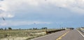 On the road again in Colorado with rocky mountains in the horizon Royalty Free Stock Photo