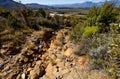 A road against a hill that was destroyed by water erosion on a farm near Worcester, Breede River Valley, South Africa Royalty Free Stock Photo