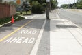 road ahead written on bike bicycle pedestrian path next to road street. ph Royalty Free Stock Photo