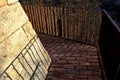 Road along the baroque bastion. modern railing made of corten sheet metal. The sidewalk is paved with burnt bricks. the high wall