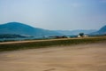 The road along the coastline. On the horizon, mountains, sea and ships Royalty Free Stock Photo
