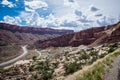 Winding road through Arches National Park in Utah on a sunny day with clouds in sky Royalty Free Stock Photo