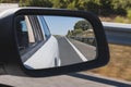 Road as seen from the rearview mirror of a car Royalty Free Stock Photo