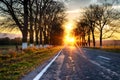 Road. Asphalt road among autumn trees. Road marking. Setting sun Royalty Free Stock Photo