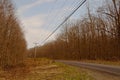 A rural country road through winter woods Royalty Free Stock Photo