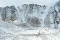 A road is barely visible as it crosses snow-covered mountains Royalty Free Stock Photo