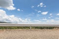 Road and barrier at with blue sky background and raincloud moving in the afternoon sunlight