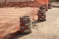 Road barrier made of garbage cans , signal tape and mesh. Entry is prohibited. Threat to the life, the construction