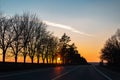 On the road with beautiful view of sunset surrounding by trees