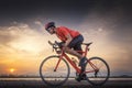 Road bike cyclist man cycling. Biking sports fitness athlete riding bike on an open road to the sunset. Royalty Free Stock Photo