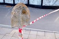 Road blocked for repair. Line stop tape tied to an old spade