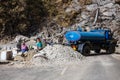 Road blocked with workers and blue truck for fixing the road in winter near the way to Tsomgo Lake in Gangtok. Sikkim, India Royalty Free Stock Photo