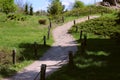 The path is ornate leading upwards among the garden, greenery.