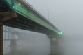 Road bridge fading into the heavy fog over the Missouri river Royalty Free Stock Photo