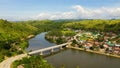 Town on the river bank and road bridge, top view. Road bridge on the island of Samar, Philippines. Royalty Free Stock Photo