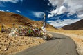 Road and Buddhist prayer flags lungta at Namshang La pass. Lad Royalty Free Stock Photo