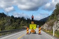 Road building traffic light signal. Mountain road stop here sign. Road works ahead Royalty Free Stock Photo