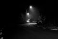 Road in Campos do JordÃÂ£o photographed at night with fog in black and white Royalty Free Stock Photo