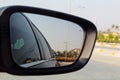 Road in car side-view mirror