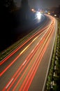 Road with car traffic at night with blurry lights