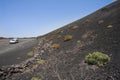 Road with car beside volcanic ashes mountain Royalty Free Stock Photo