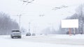 Road in the city with cars in the winter, a lot of snow. Billboard, place for text, copy space Royalty Free Stock Photo