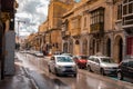 Road in the city of Valletta packed with cars and other traffic. Typical street in the mediterranean island of Malta on a rainy